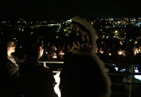 large group of people holding candles