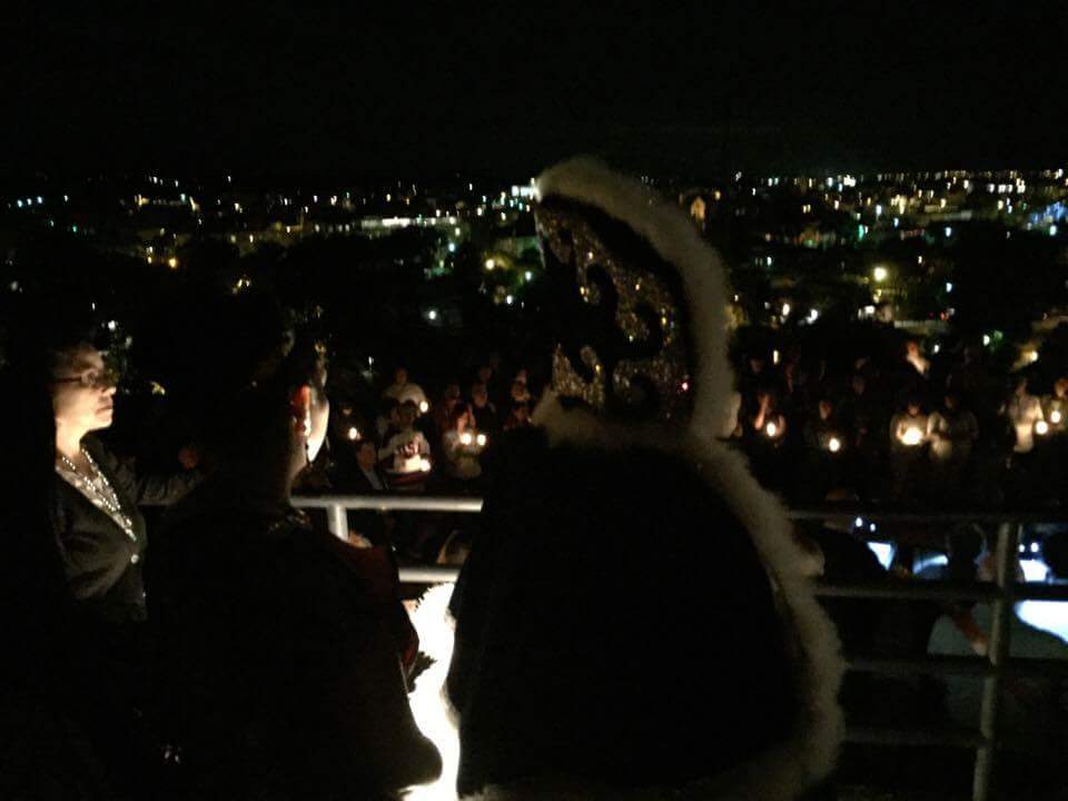 large group of people holding candles