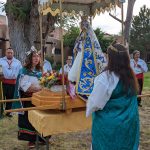 Women holding up an altar at Santa Fe Fiesta