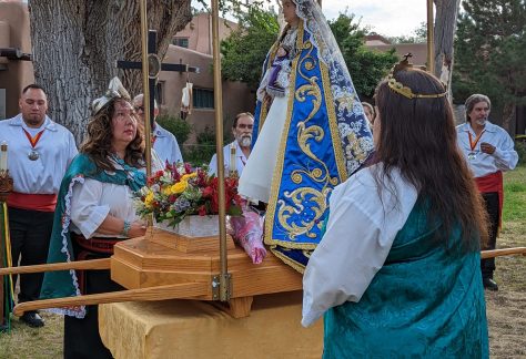 Women holding up an altar at Santa Fe Fiesta