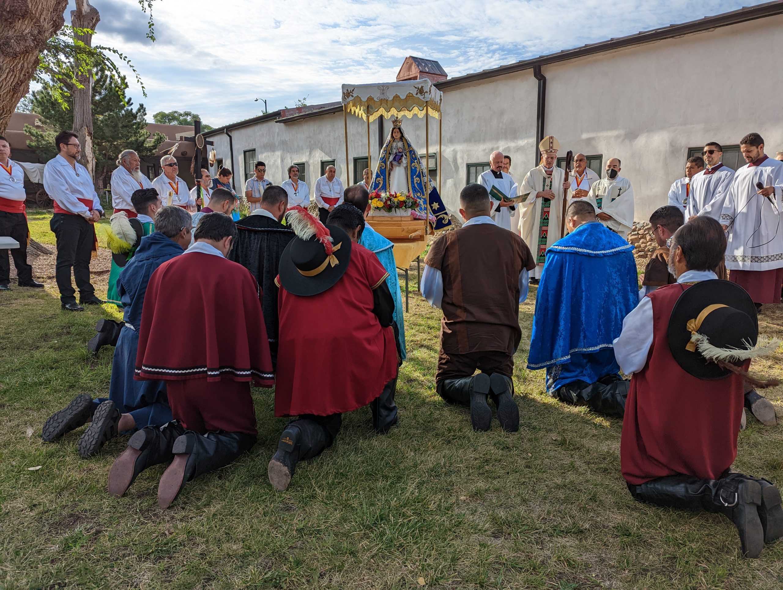 People praying to altar at Santa Fe Fiesta