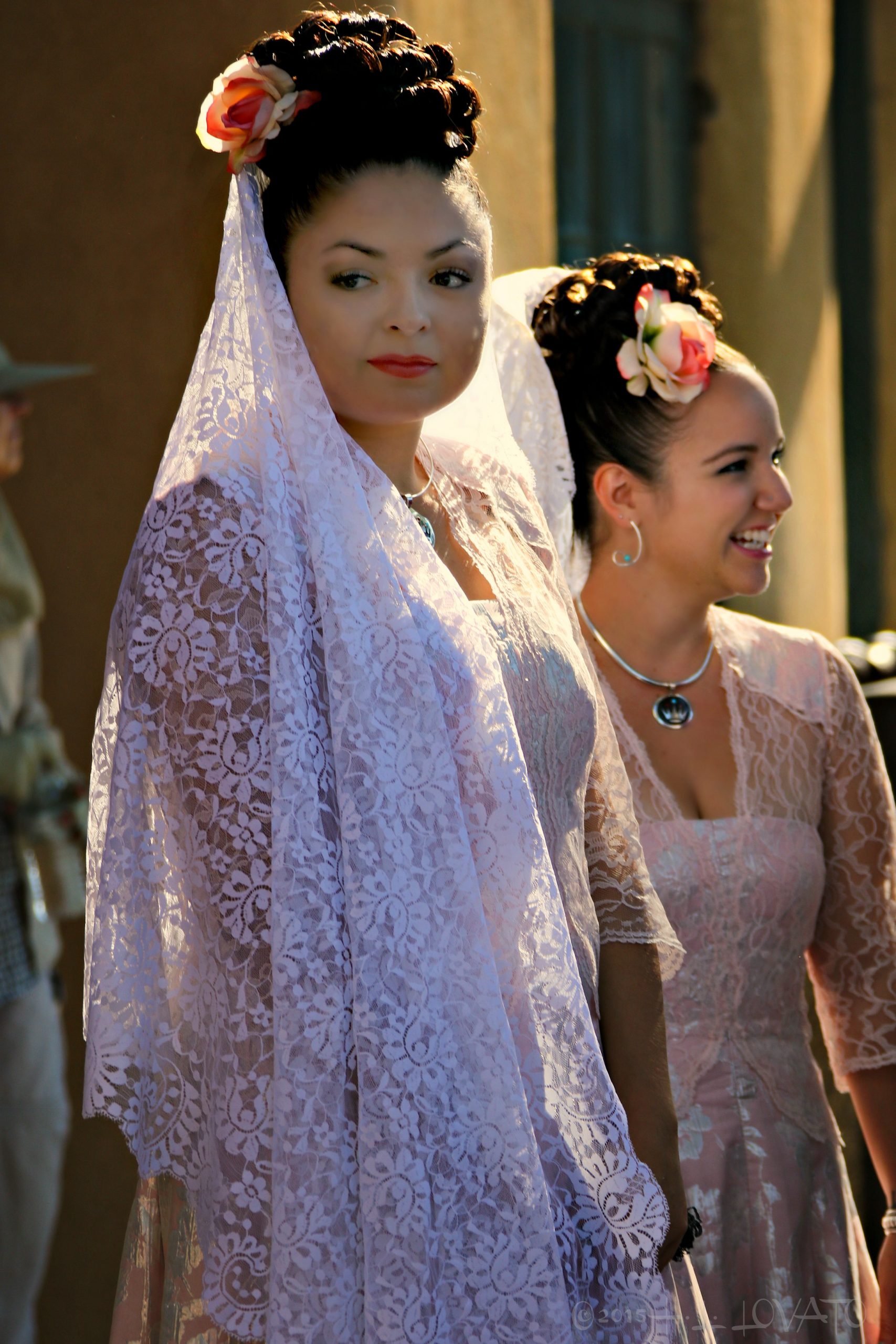 Two young women dressed in lace gowns