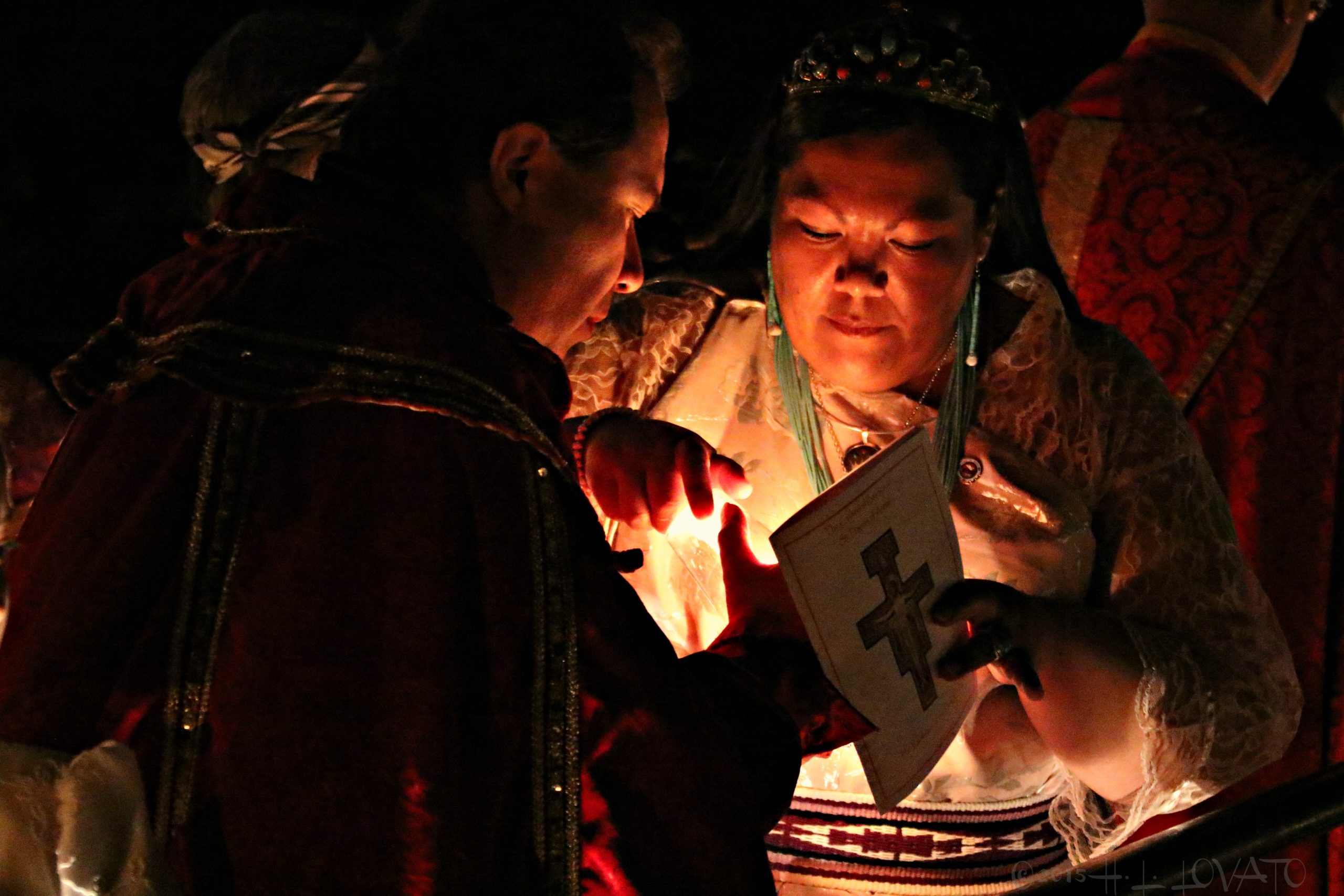 Man and woman lighting a candle