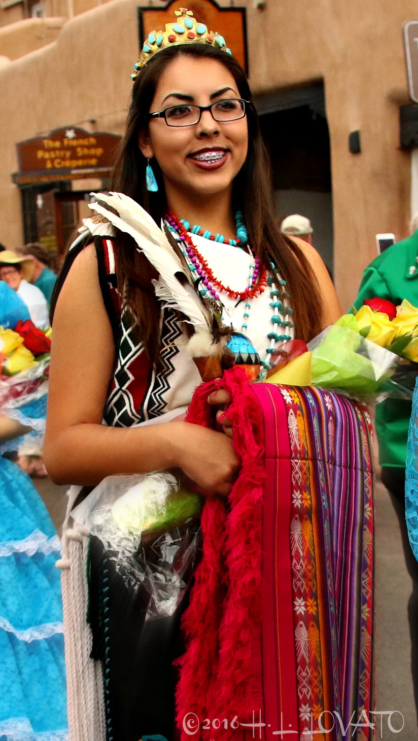 Woman dressed in traditional attire holding a bouquet of flowers