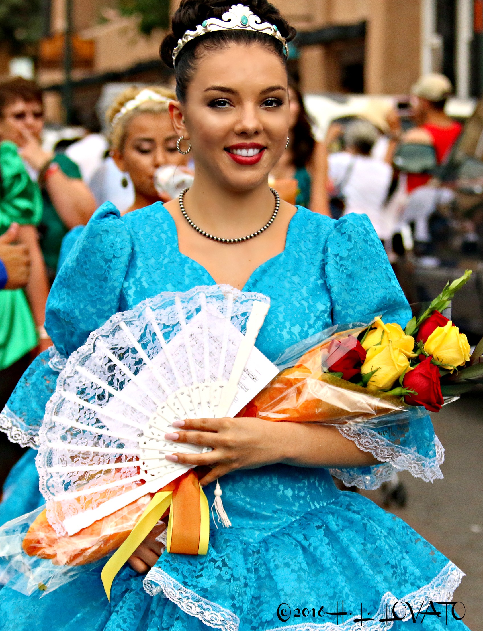 Woman in blue gown holding a bouquet of flowers